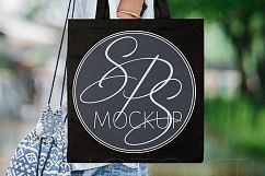 Woman holding Black Tote Bag Mockup Product Image 1