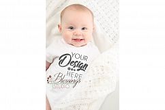 Mockup Closeup of baby modeling a Blank White Baby Bodysuit Product Image 1
