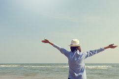 young woman standing arms outstretched back and enjoy life Product Image 1