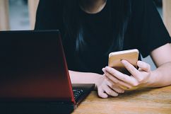 Woman using smartphone in cafe Product Image 1