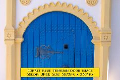Ornate Archway and Blue Door Tunisia Street Scene Product Image 1