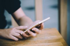 Woman using smartphone in cafe Product Image 1