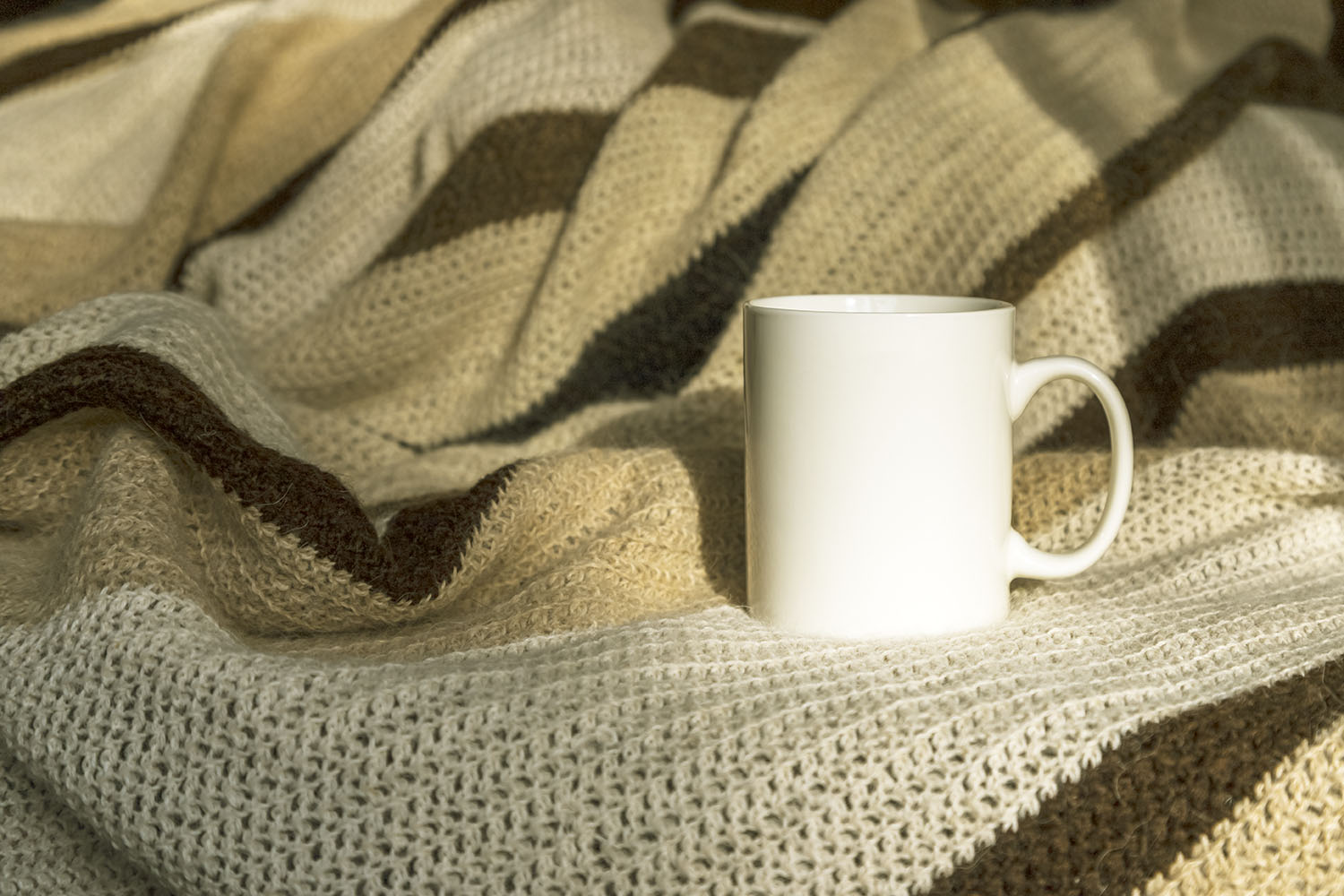 Download White coffee mug mockup with striped blanket.