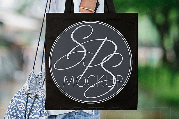 Woman holding Black Tote Bag Mockup
