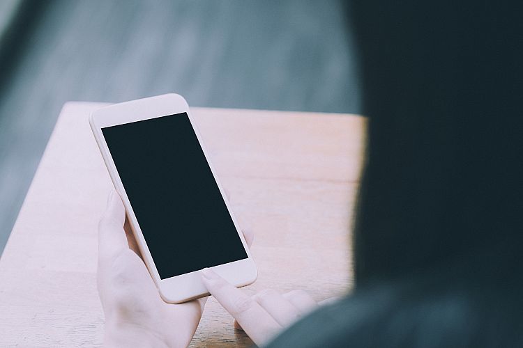 Young hipster woman using smartphone