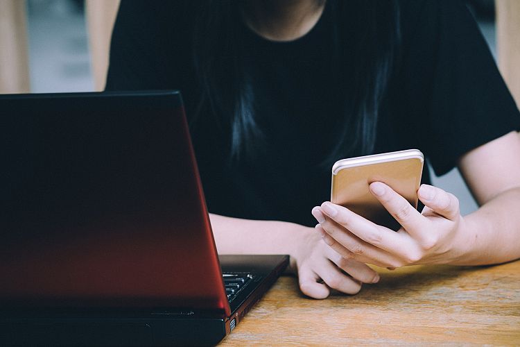 Woman using smartphone in cafe
