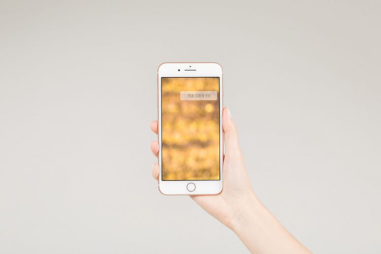 Female holding white smartphone with blank screen 