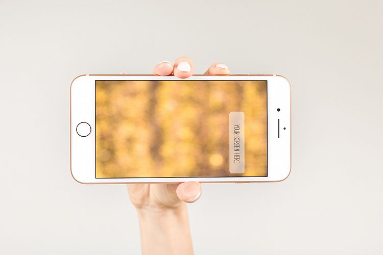  Female holding white smartphone with blank screen 