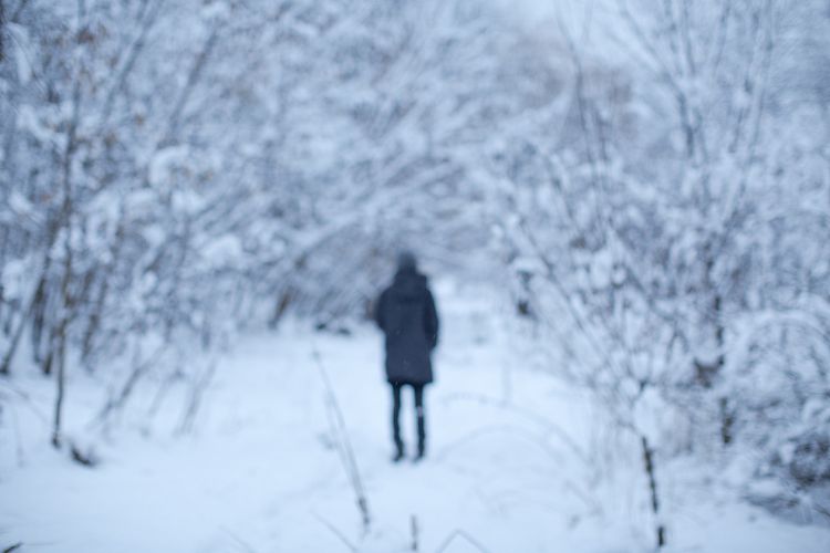 Blurred girl in snow forest