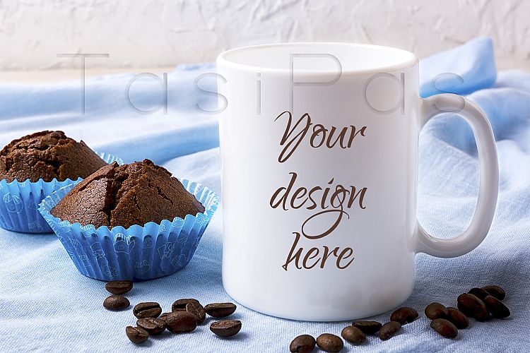 White mug mockup with coffee beans and two chocolate muffins