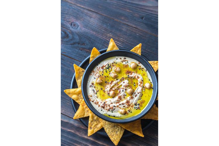 Bowl of hummus with tortilla chips example image 1