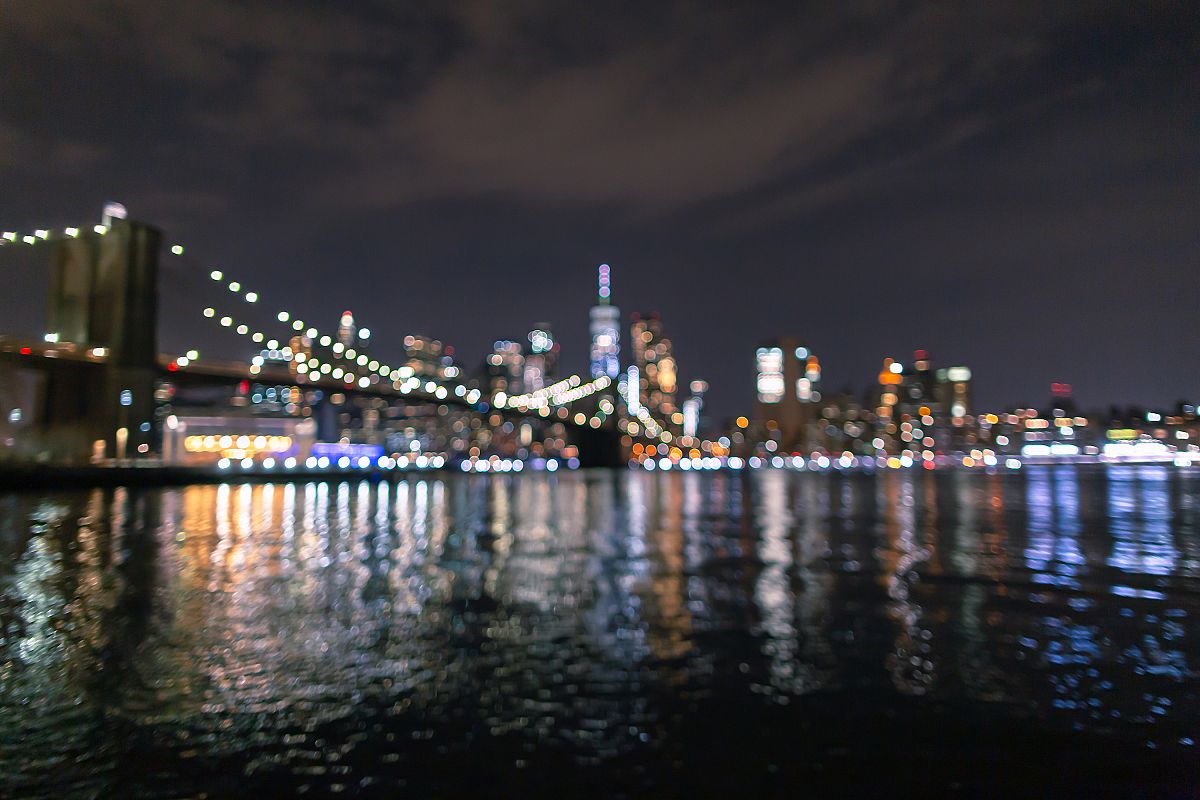 Blurred view of Financial District at night from East River example image 1