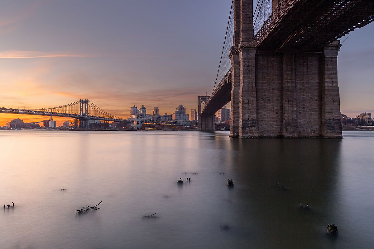 Brooklyn and Manhattan Bridges at sunrise from East River example image 1
