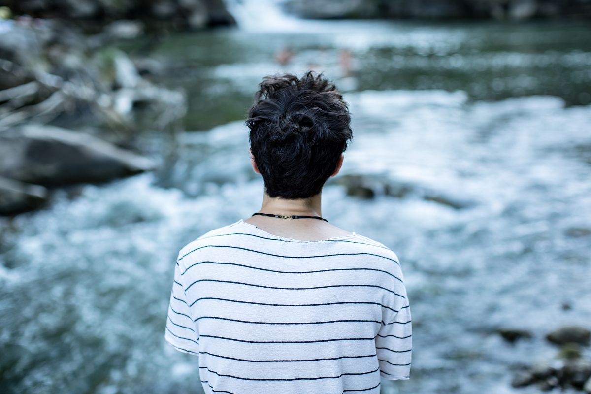 Man sitting at the waterfall example image 1