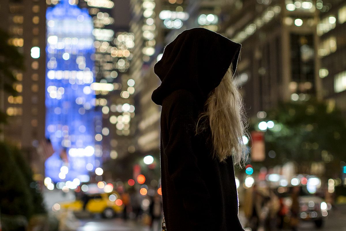 Women in dark parka walking in Manhattan example image 1