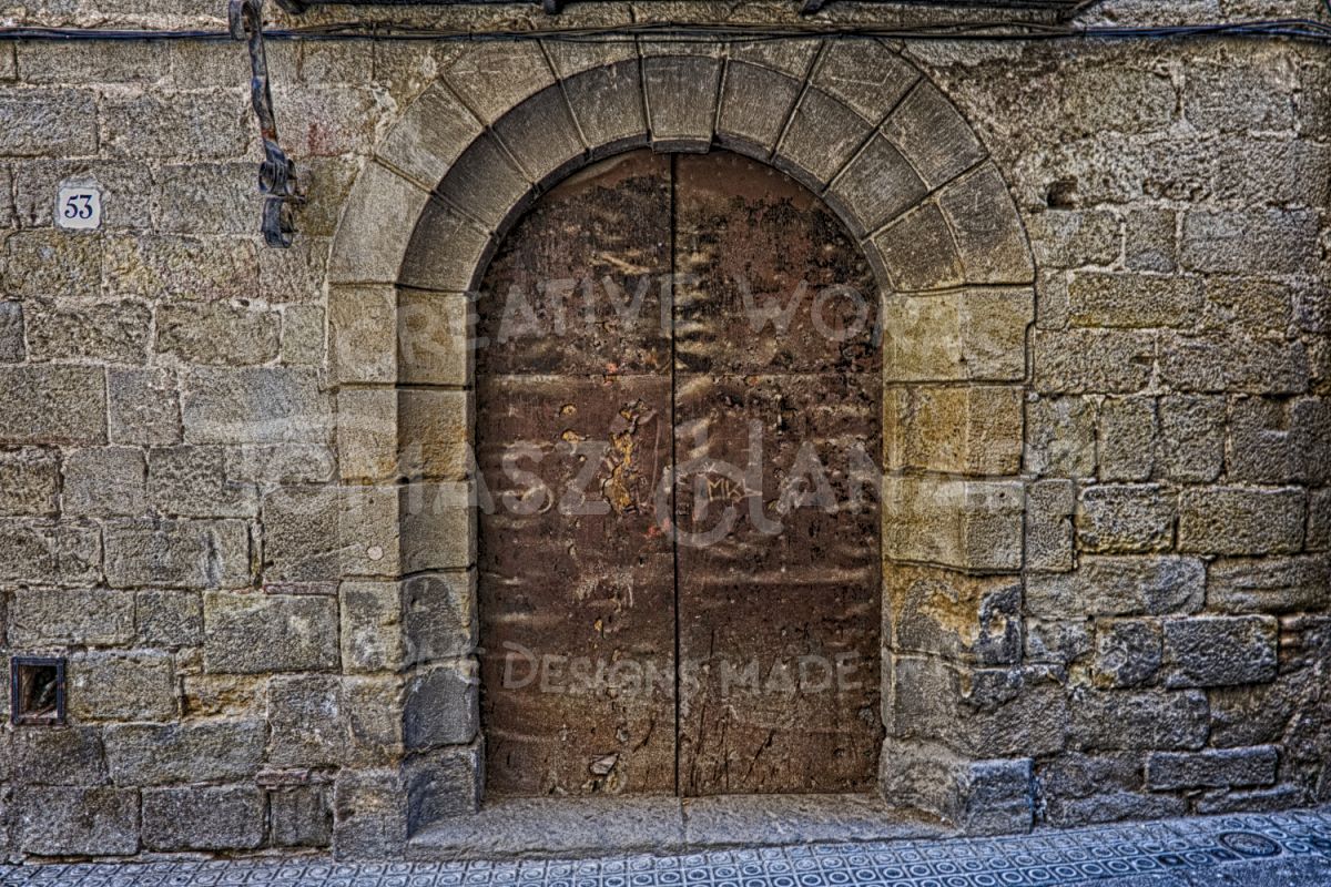 Old Rustic Arched Door In Stone Wall example image 1