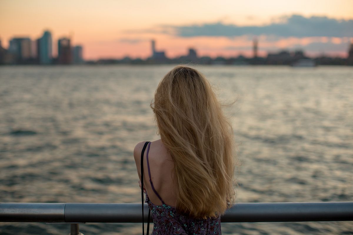 Girl enjoys sunset at the pier example image 1