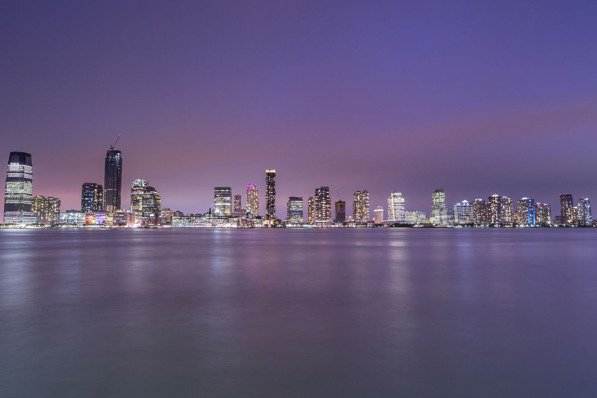 View on Jersey city skyscrapers at night from Hudson river example image 1