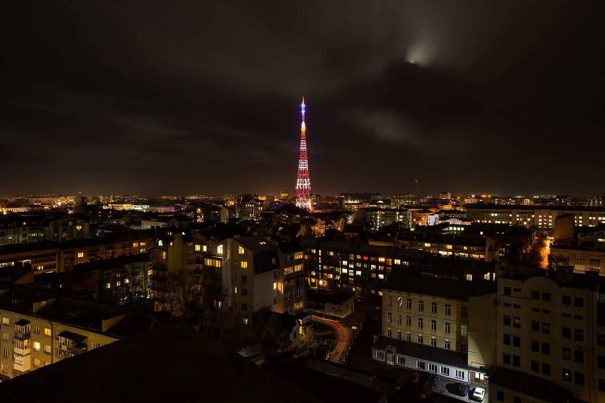 Old city with electric tower view during night example image 1