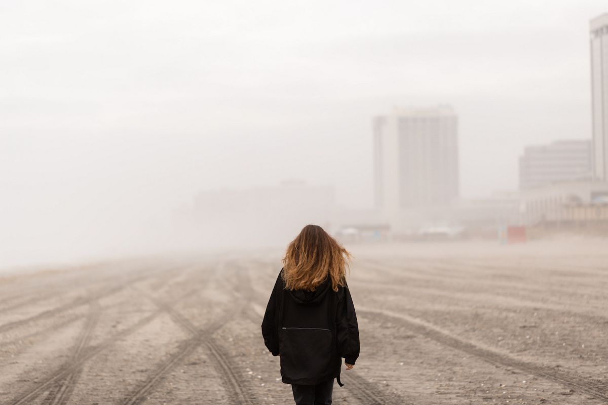 Girl on walking on the beach during fog at atlantic city example image 1