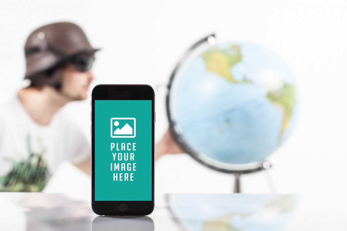 Mobile smart phone with blank screen , blur image of traveler whit globe on back example image 1