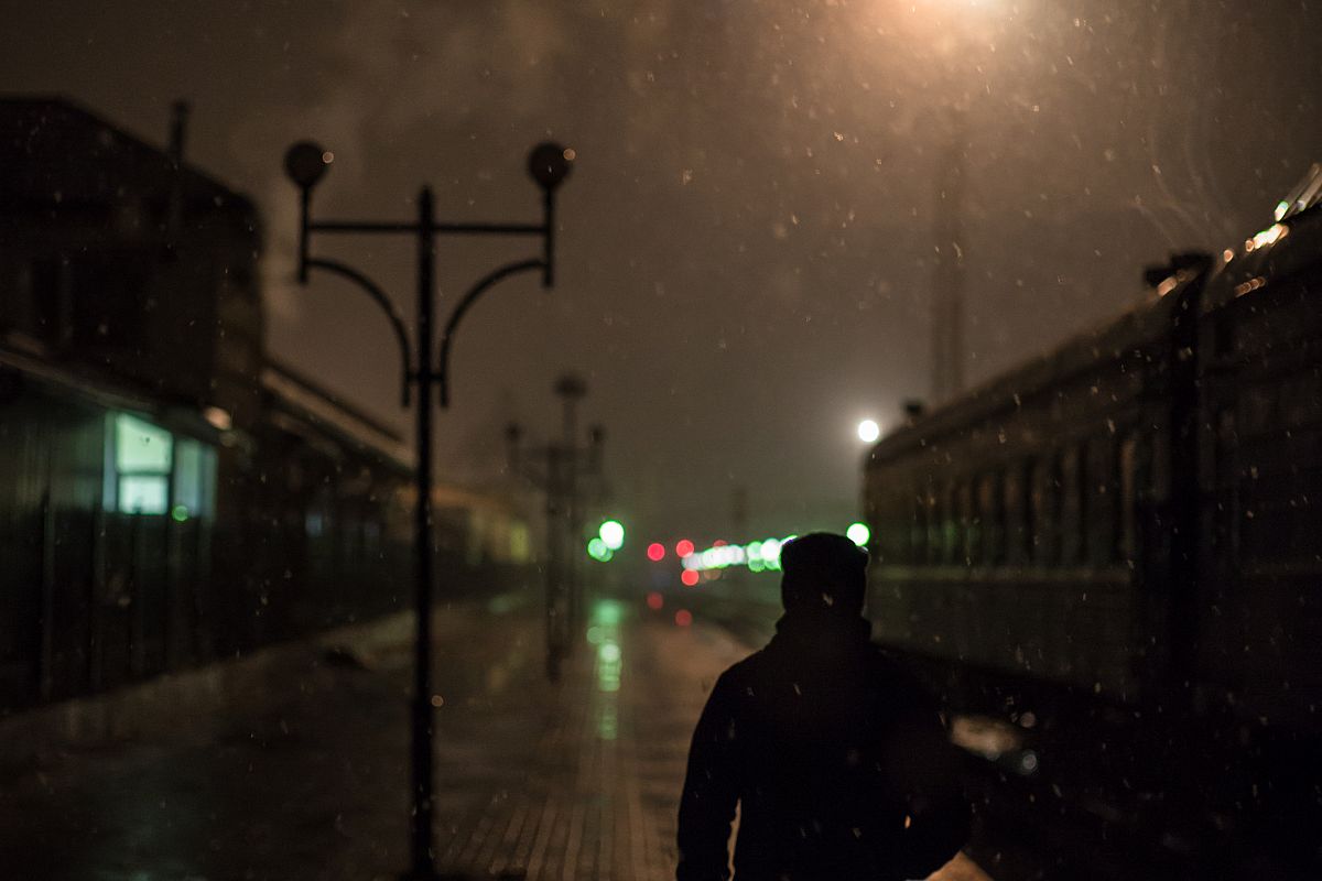Man on a train station at night example image 1