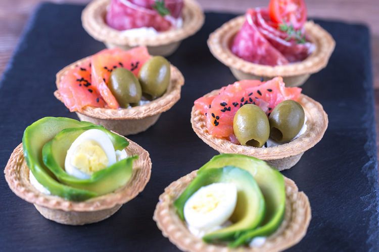 Tartlets with different fillings on the stone board example image 1