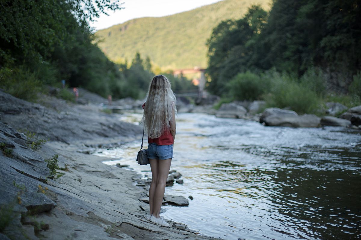 Girl at the river in mountains example image 1
