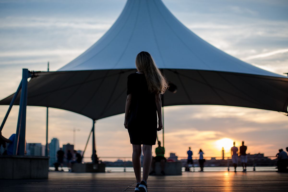 Young girl walking to sunset example image 1