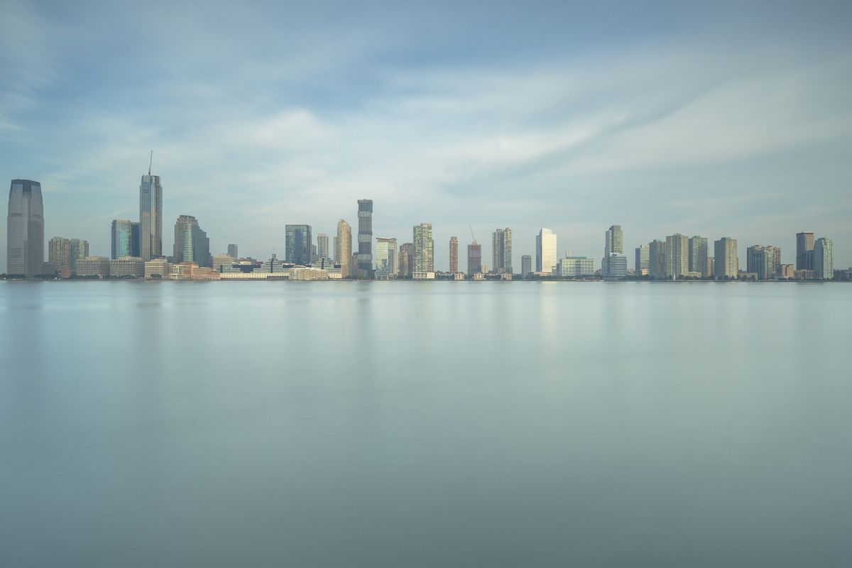 Jersey city coastline from hudson river at sunrise example image 1