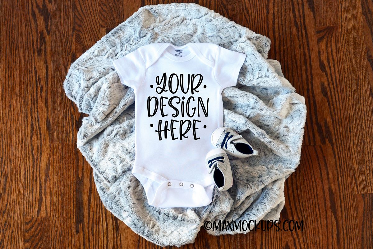 White baby bodysuit mockup with grey fur and baby shoes example image 1