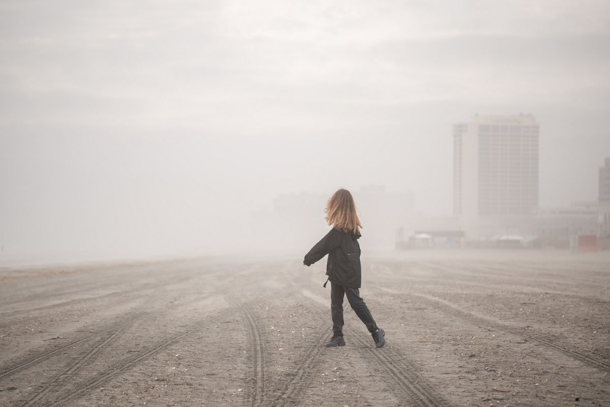 Girl on walking on the beach during fog at atlantic city example image 1