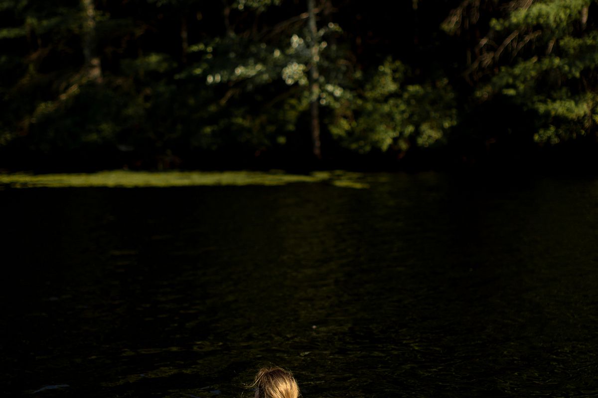 Girl swimming in lake at wood example image 1