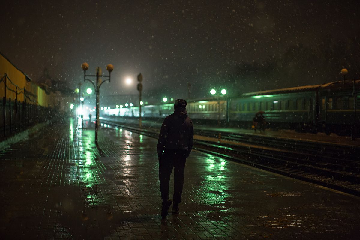 Man on a train station at night example image 1