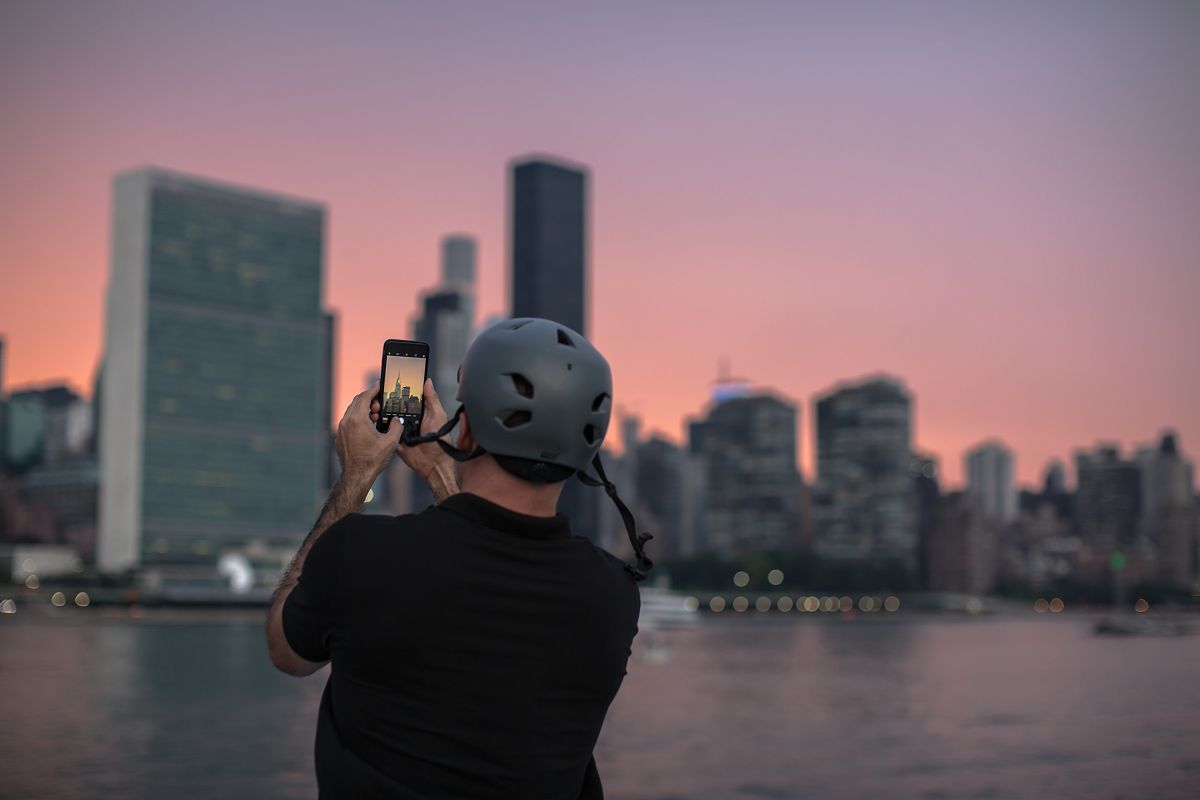 Man taking photos during sunset in the city example image 1