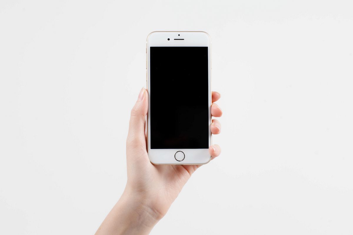 Hand holding mobile smart phone with blank screen example image 1