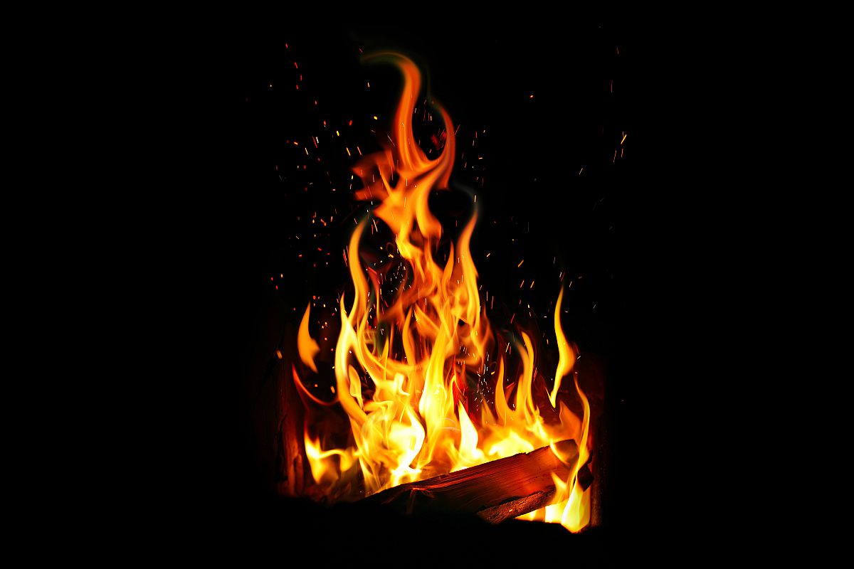 burning log and fire on black