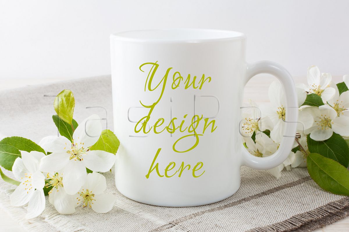 White coffee mug mockup with blossoming apple tree branch. example image 1