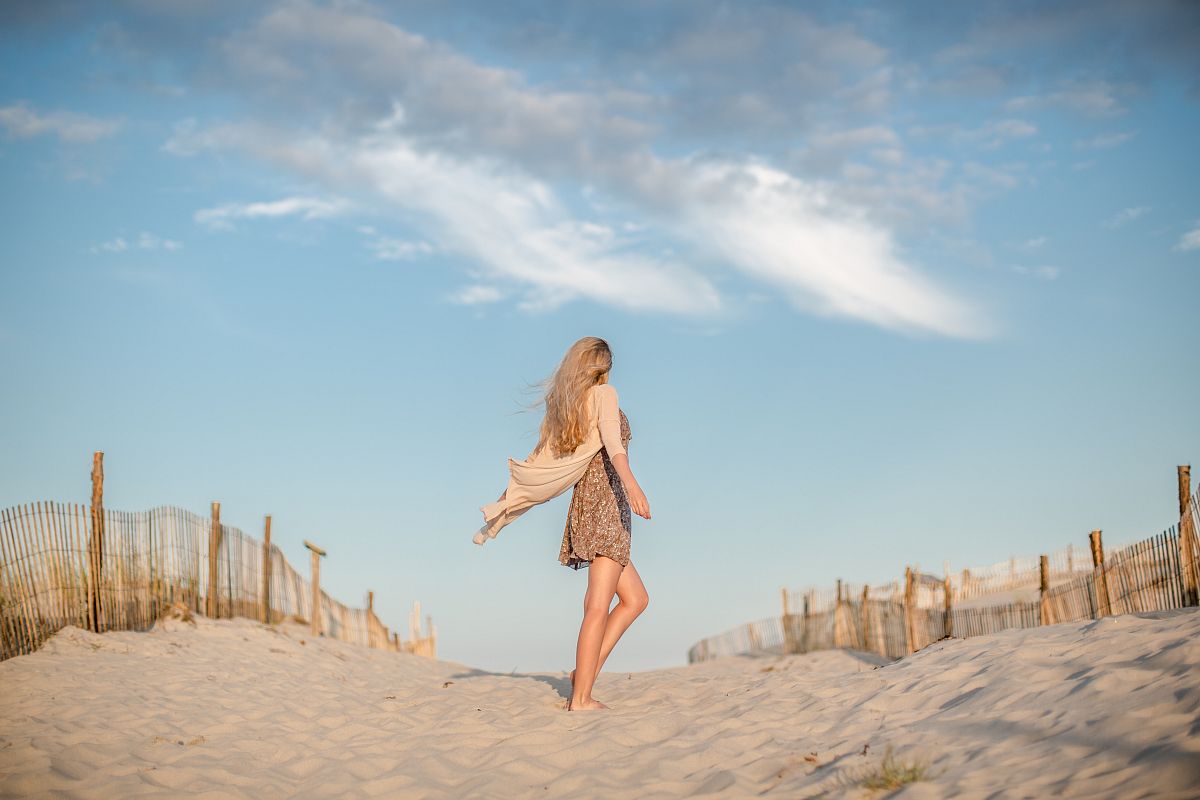 Women dancing on the beach during sunset example image 1