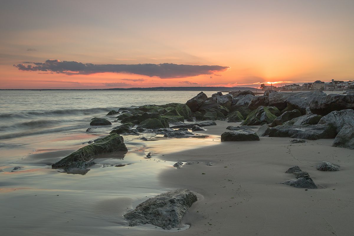 Sunset on the beach with rocks example image 1