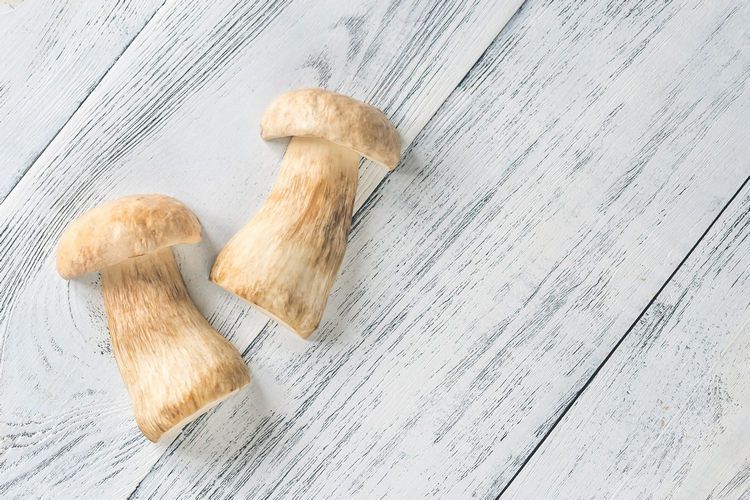 Halved porcini mushroom on the wooden background example image 1