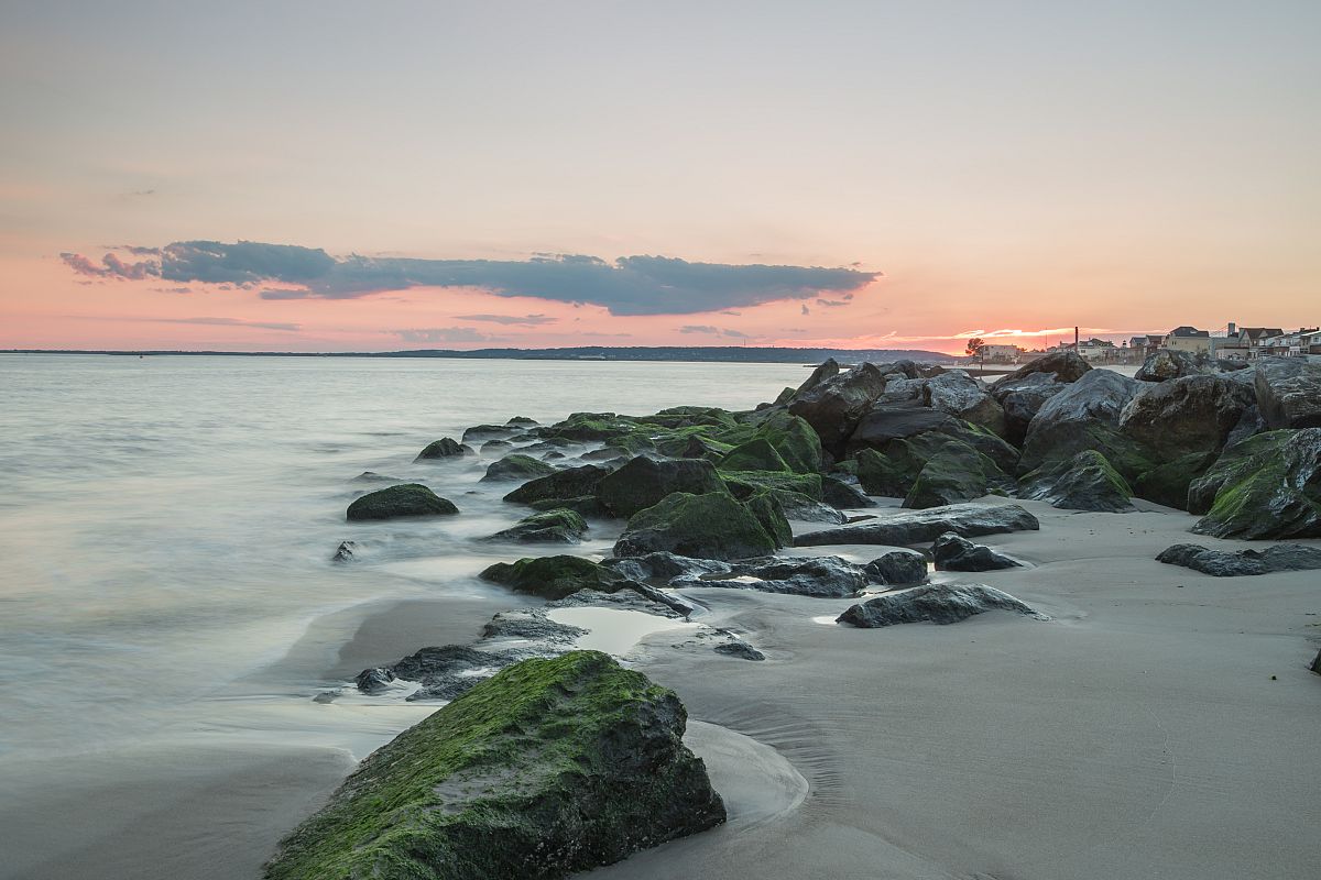 Sunset on the beach with rocks example image 1