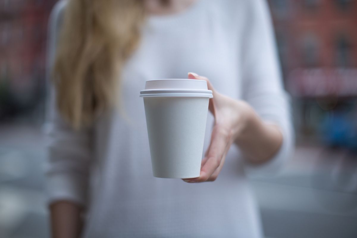 Women hand holding paper cup example image 1