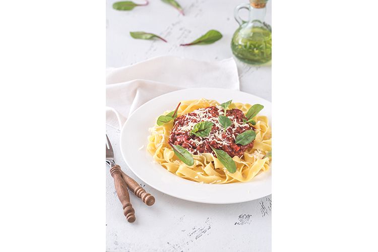 Portion of tagliatelle with bolognese sauce example image 1