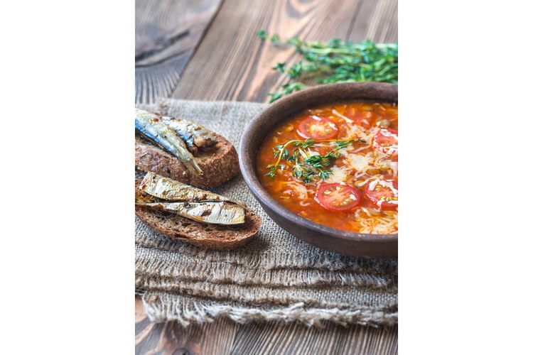 Portion of green lentil tomato soup with toasts example image 1
