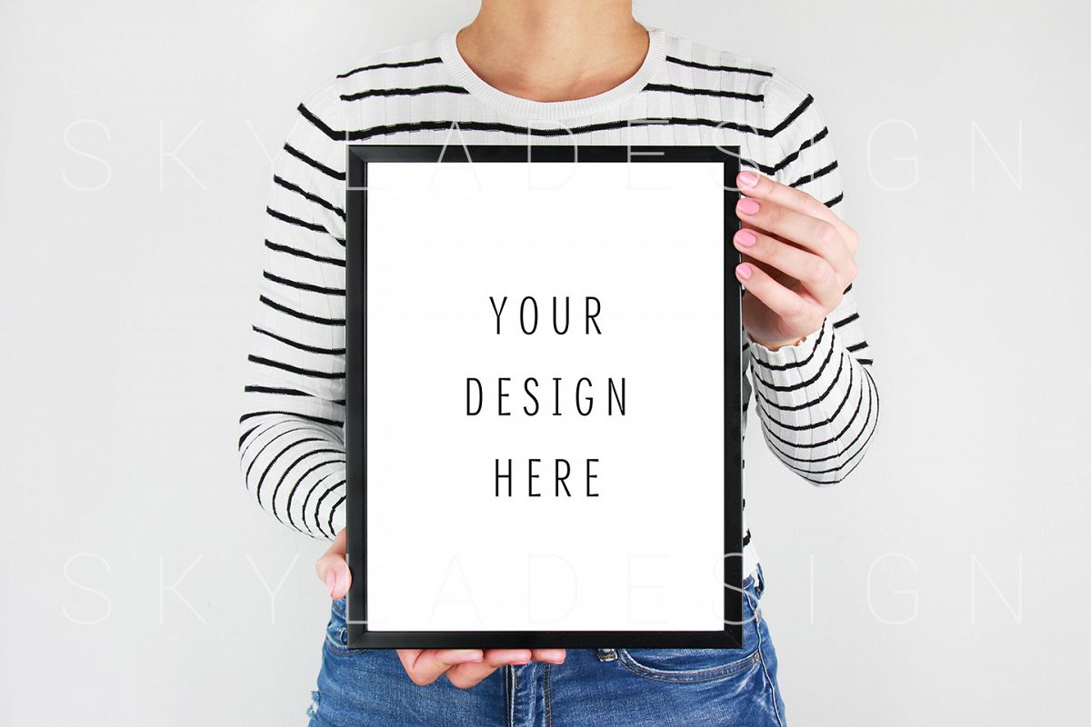 Woman holding black picture frame mockup example image 1