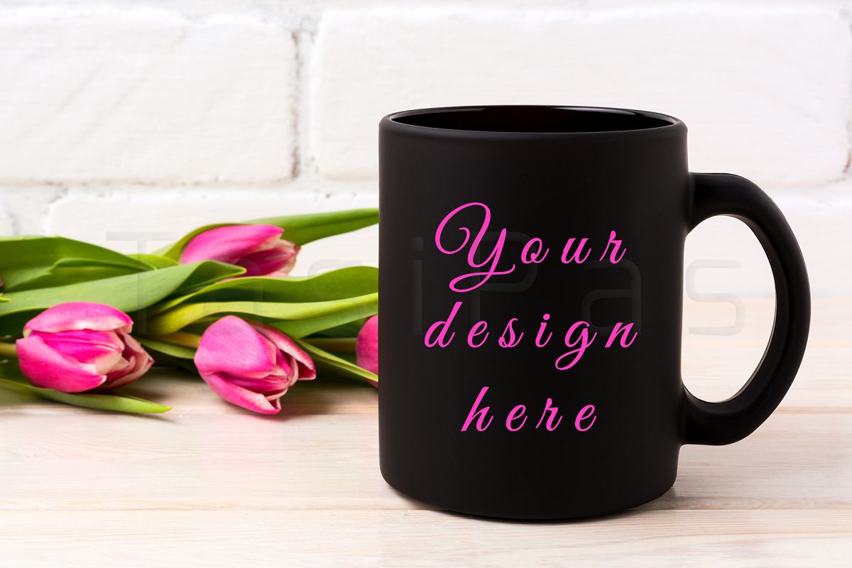 Black coffee mug mockup with rich magenta pink tulips bouquet near painted brick wall. example image 1