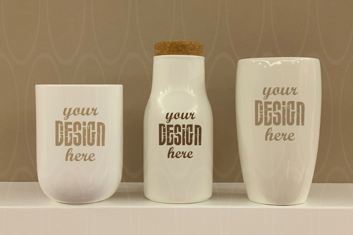Blank Two White Coffee Cups and bottle on white table Mockup example image 1