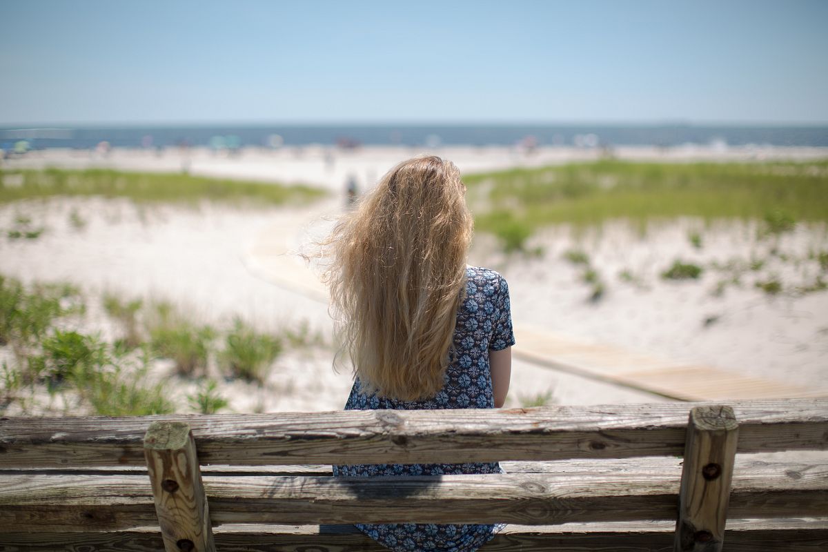 Women sitting on the bench at the ocean example image 1