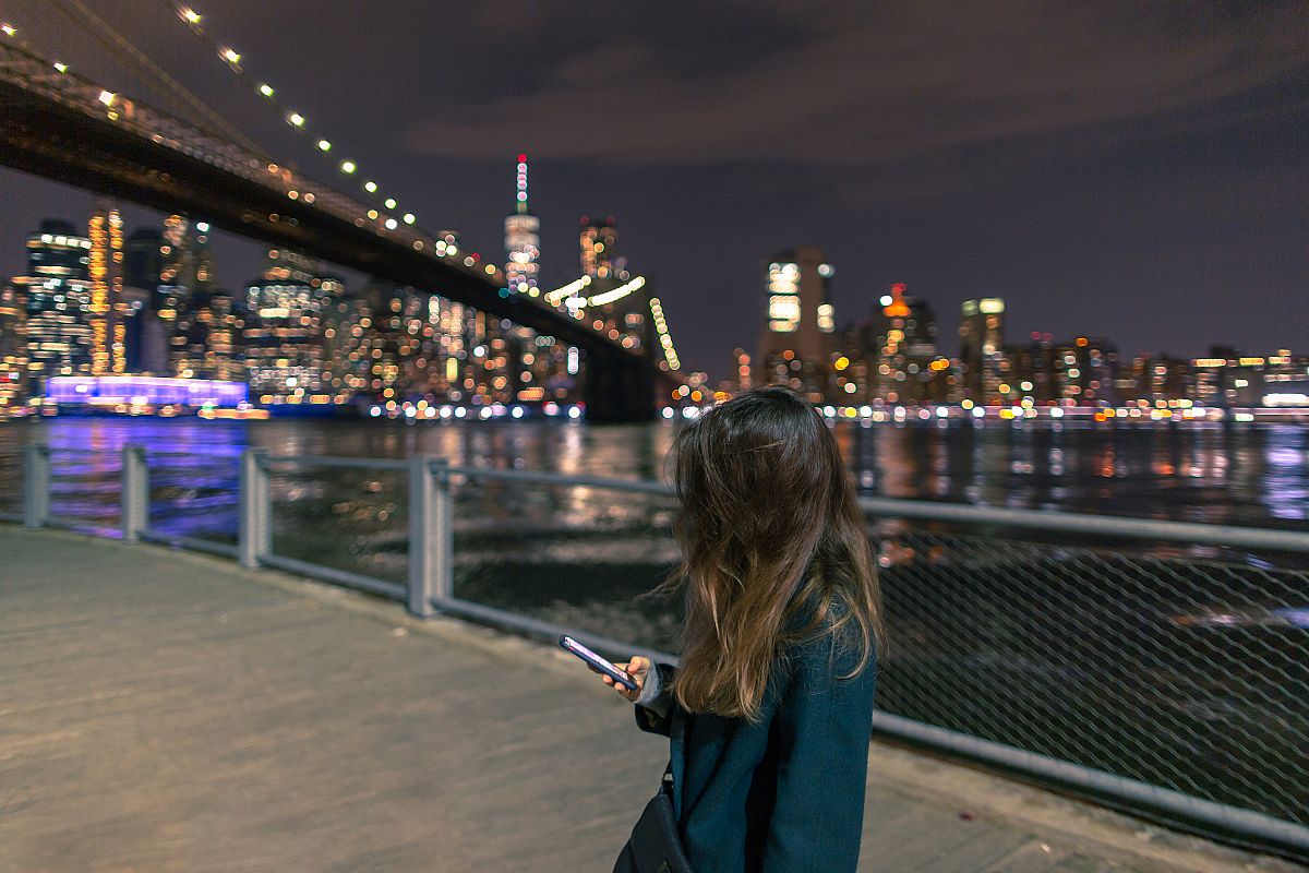 Women on the smartphone in New York at night example image 1